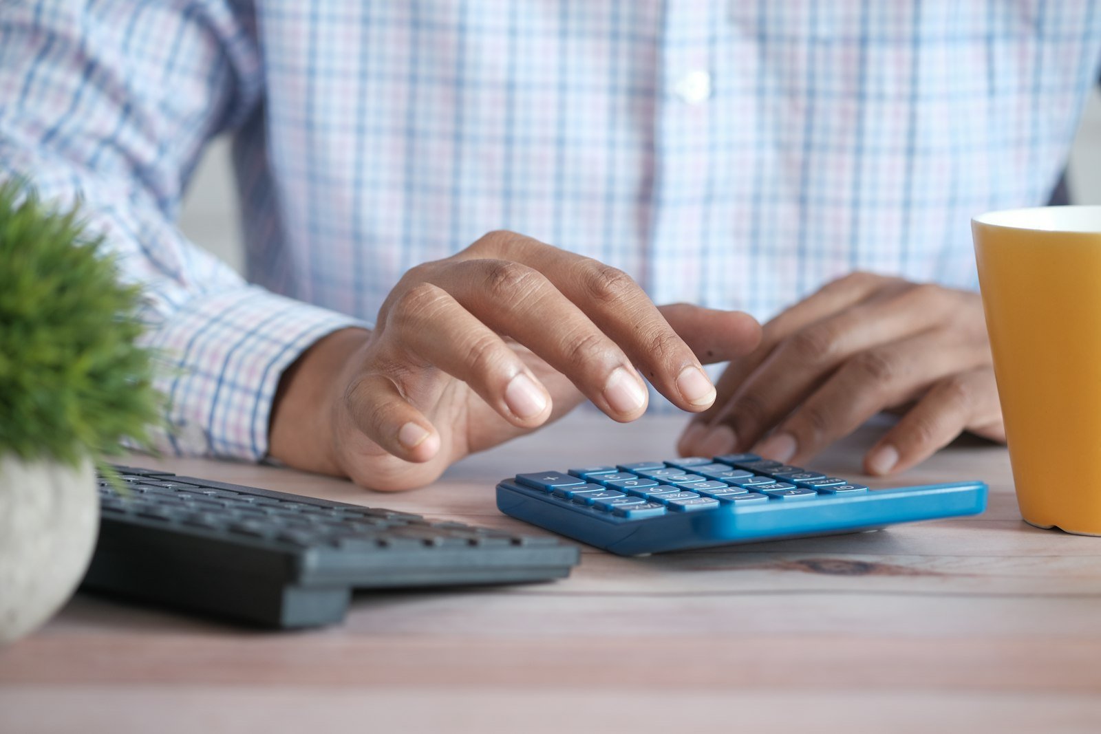 owner working out fixed and variable costs on a calculator